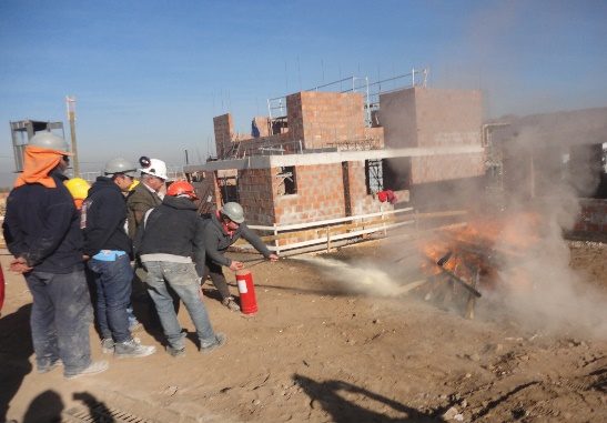 Simulacro de emergencia con extintores en obra de construcción